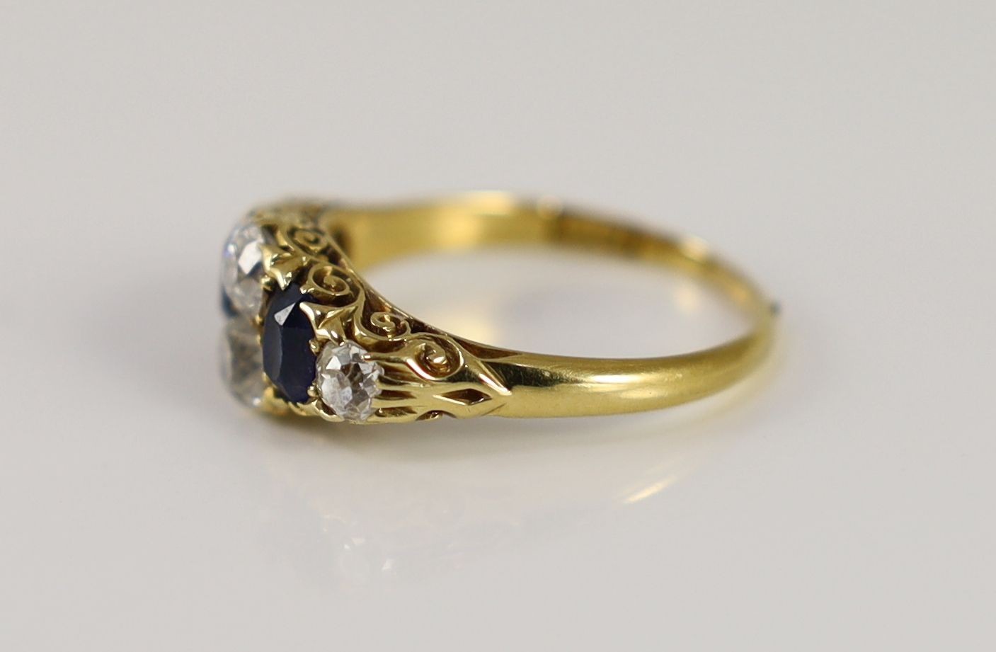 A Victorian style 18ct gold, four stone old round diamond and two stone sapphire set ring